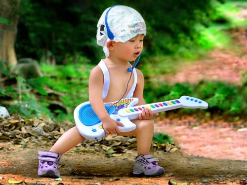 Cute Baby Boy Playing Guitar