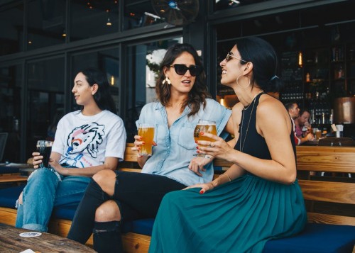 Three women holding drinking glasses