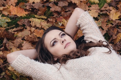 Beautiful Girl In The Park Lying On The Leaves