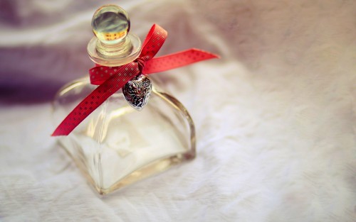 Perfume bottle with heart and ribbon