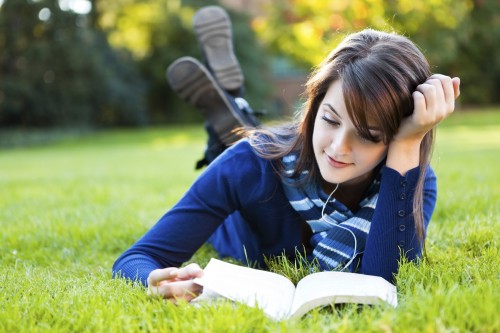 Girl Reading Book In Garden