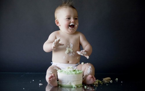 Naughty baby happy with cake