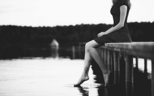 Girl sitting lake
