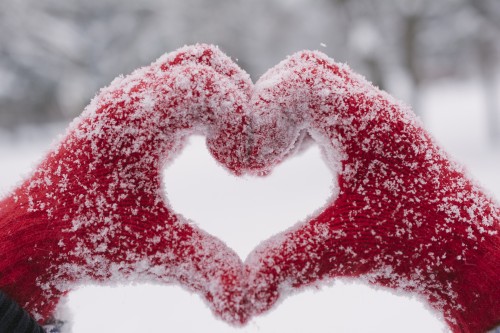 Snowy heart shape hands