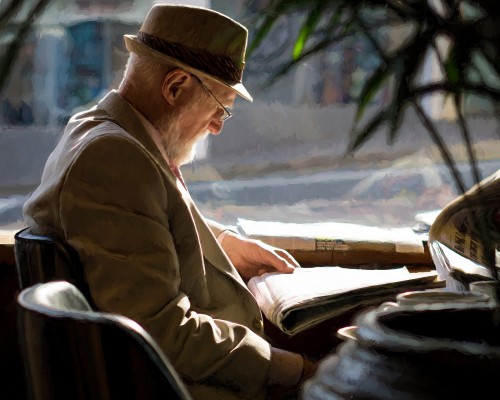 Gentleman reading newspaper in coffee shop