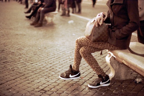 A fashionable girl wearing leopard print leggings.