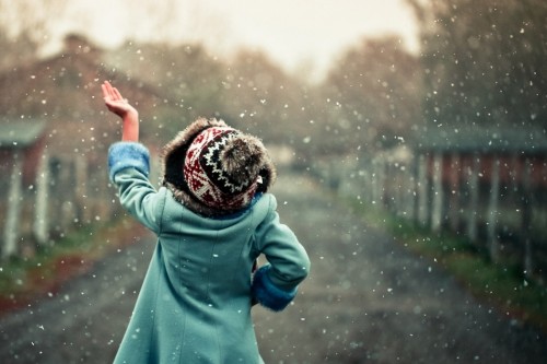 Little girl catching snow