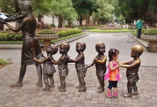 A girl dancing with statues