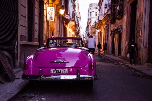 Pink vintage car on the road