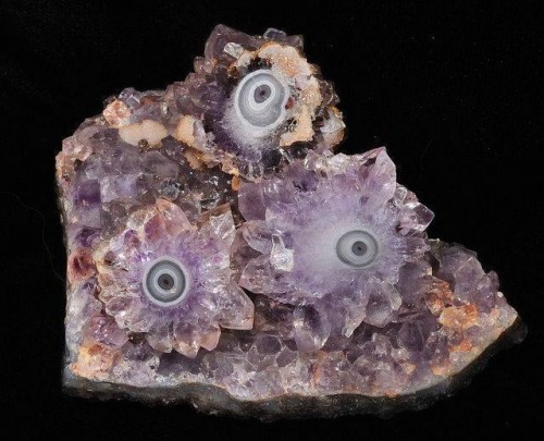 An amethyst cluster with aqate eyes.