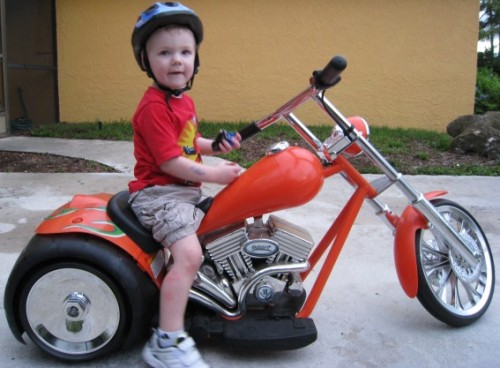 Little Boy Sitting On The Volt Bike