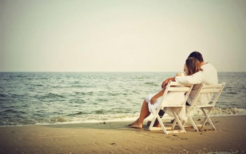 Romantic Couple Seating on Beach