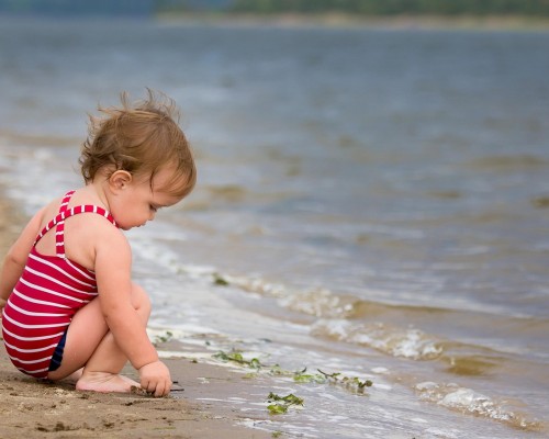 Baby playing on beach