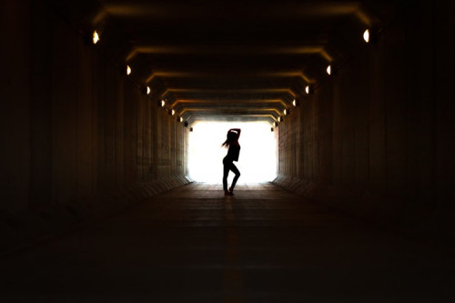 Woman walking on tunnel