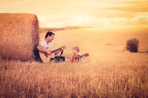 Enjoy guitar cute son and Father