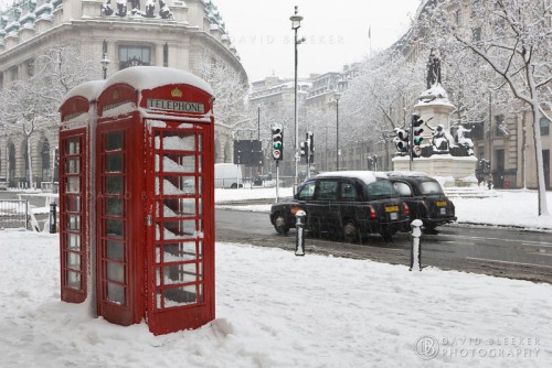 Red Phone Boxes In London's West-End Covered In Snow.