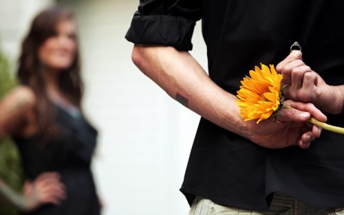 Boy proposing girl with ring flowers