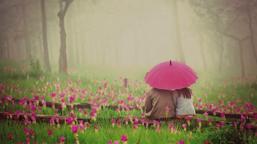 Couple sitting under an umbrella